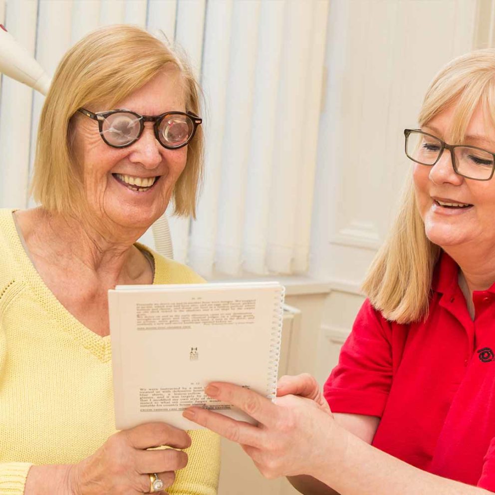 Photo of our worker demonstrating eccentric reading to a service user