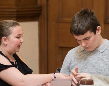 Two young people talking to each other at a Visibility Scotland event