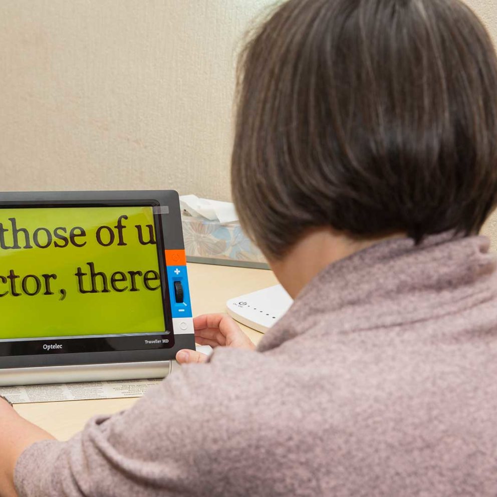 Lady using an electronic magnifier
