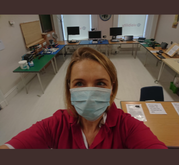 Our CEO, Laura Walker, wearing a face mask in our resource centre at Queen's Crescent. Aids and equipment for demonstration are placed around the room.