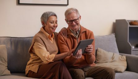 couple on a couch using a tablet computer