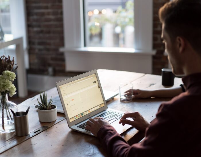 Young man working on a laptop at his desk