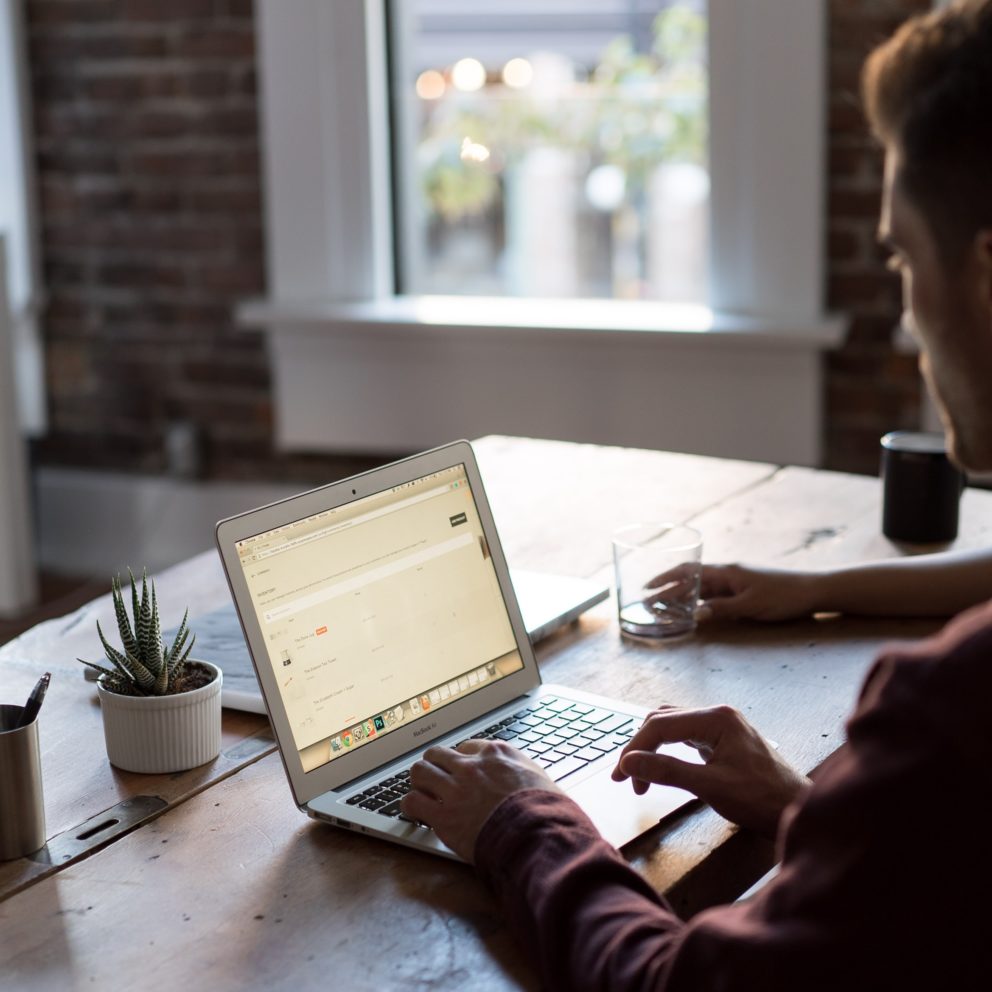 young man working on laptop at desk