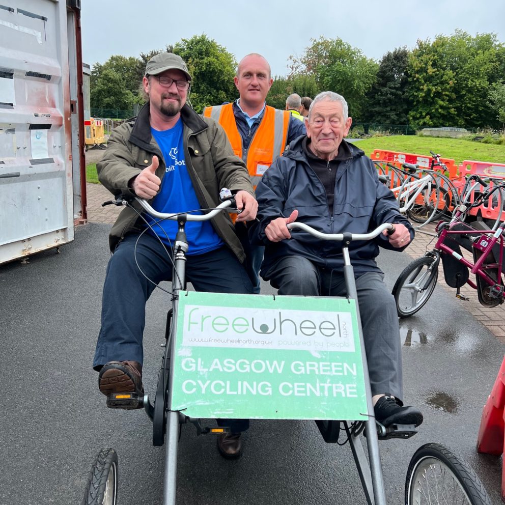 Visibility Scotland staff member, Andy, and service user, Alfie, ready to try out a side by side bike at our cycling event with Free Wheel North.