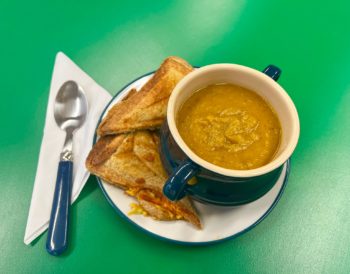 A bowl of soup and a toastie