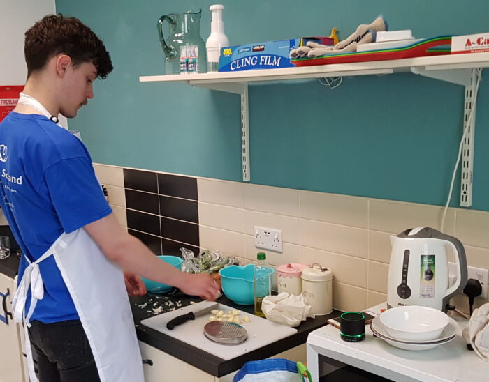 The Haven's chef, Xander, preparing food in the kitchen.