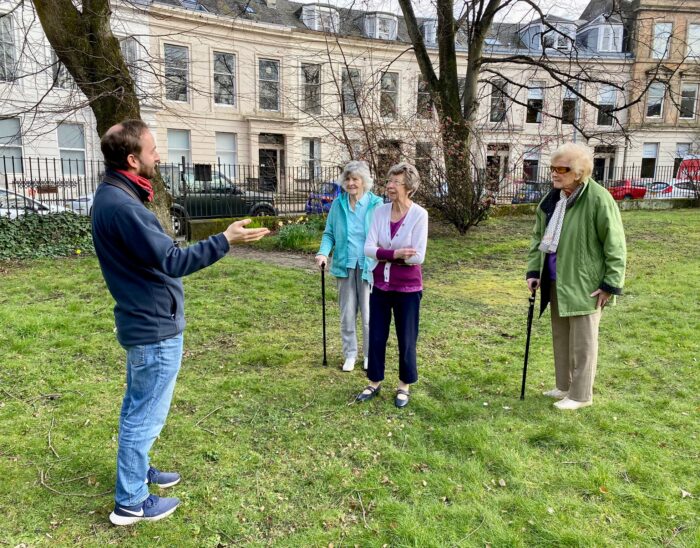 David from RSPB talking to three participants at our Spring birdsong event in the garden at Queen's Crescent.