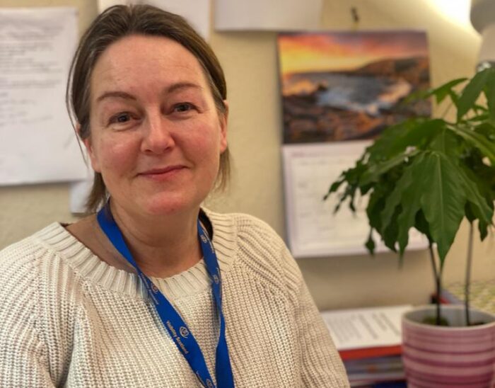 Claire MacLaverty smiling at her desk