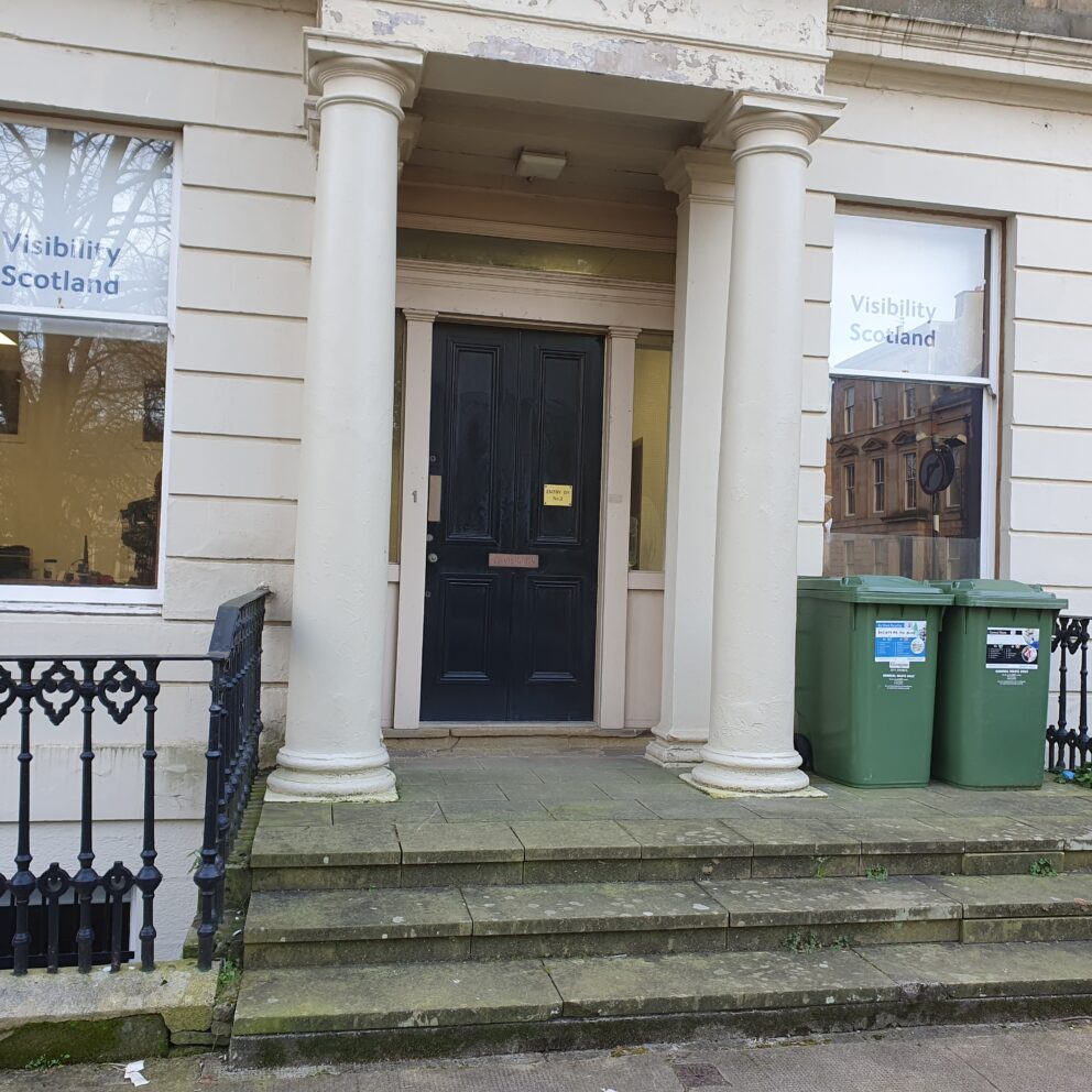 Entrance to 1 Queen&#039;s Crescent. There are three concrete stairs leading up to a black door