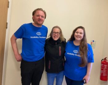 Two Visibility Scotland staff with one of the Right to Dream ambassadors