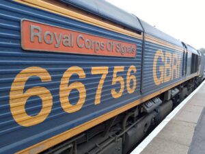 Side of a blue train car with the words "Royal Corps of Signals" and the number 66756 printed on it