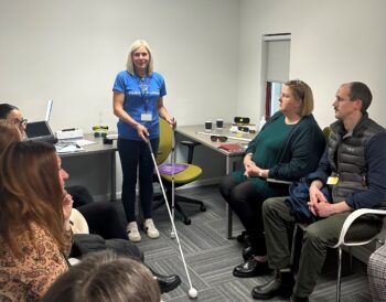 A Visibility Scotland rehabilitation specialist teaching long cane techniques