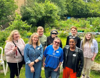 Sharon and Aarti from Freedom and Joy stand with Lynsey, Visibility Scotland staff member, and the young people who attended the 2025 summer pizza party.