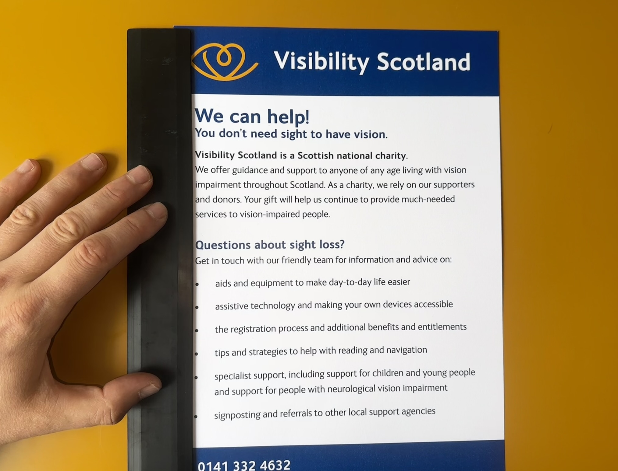 A ruler placed as a visual anchor on the lefthand side of a pamphlet