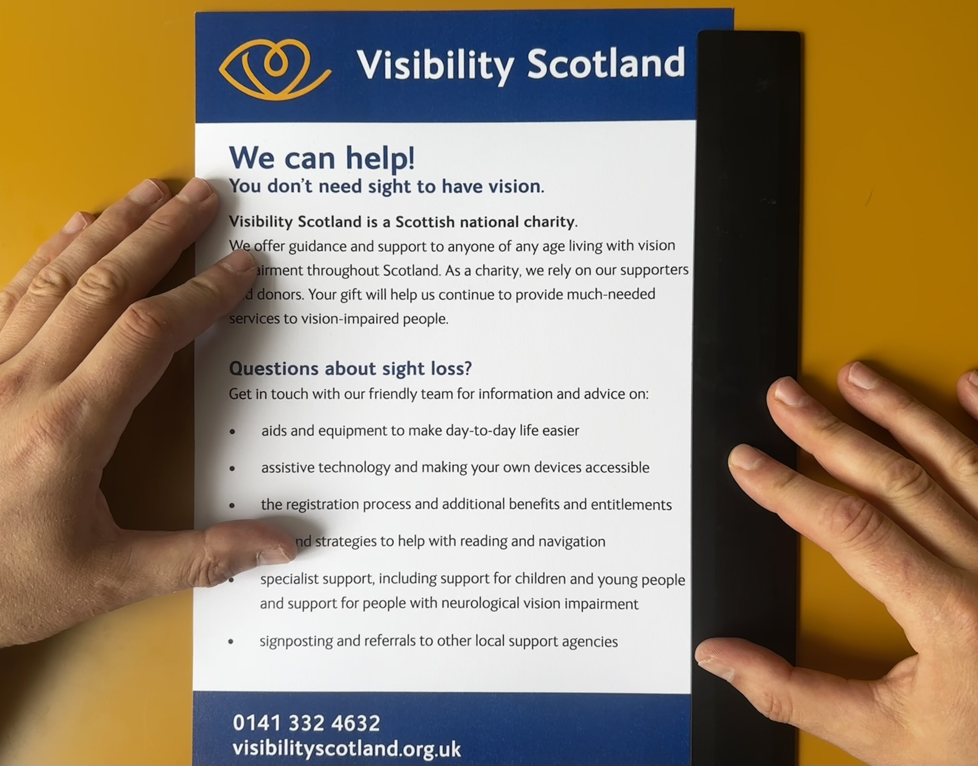 A ruler placed on the righthand side of a pamphlet as a visual anchor