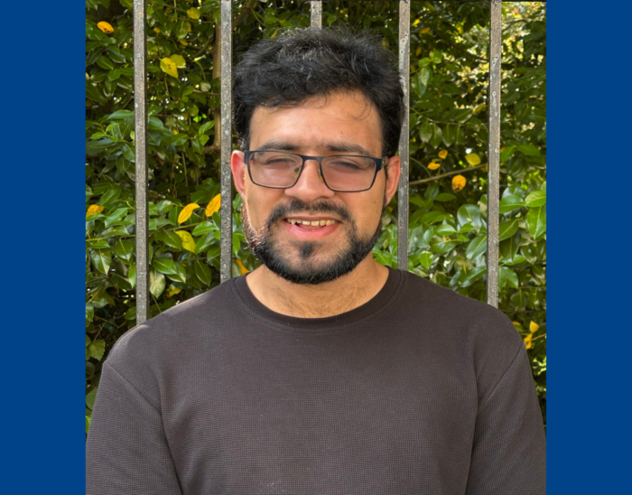 Visibility Scotland board chair Aqeel stands outside smiling.